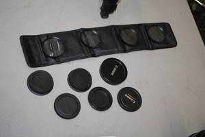 lot 1034 image: Camera Accessories - (6) Lens Caps, (4) Lenses (Closeup10) and (1) Carry Case