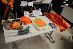 lot 1069 image: Assorted Outdoorsman Gear and Accessories - Hats, Patches, Youth Rain Gear, Targets, Signaling Flashlights