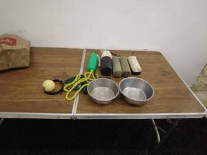 lot 28 image: Assorted Pet Supplies Bowls, Toys, and Training Dummies