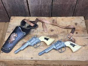 lot 221 image: Vtg Pair Hubley Cap Guns with a Leather Holster