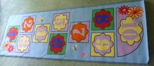 lot 10 image: Hopscotch rug 6 ft x 2 ft