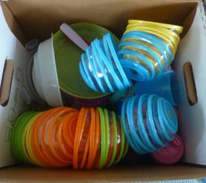 lot 33 image: Box full of plastic swirl design bowls and sippy cups