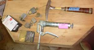 lot 209 image: locks, grease gun, Estwing Rock pick hammer