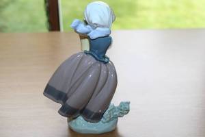 lot 2 image: Porcelain Figurine of Girl Holding Potted Flowers