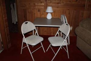 lot 143 image: Foldable Table with Padded Chairs and Table Lamp