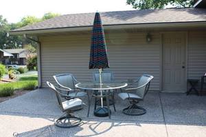 lot A-150 image: Outdoor Patio Set with Glass Table and 4 Swivel Chairs