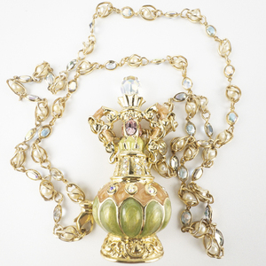 lot 256 image: Kirks Folly Genie & Magic Lamp In A Bottle Gold Tone Base Metal Necklace. Opens & Closes