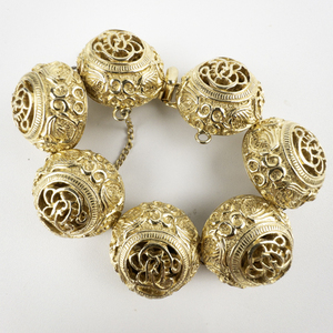 lot 101 image: Nettie Rosenstein  Intricate Floral High Dome Yellow Plated Base Metal Bracelet.