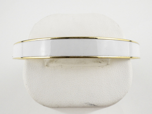 lot 103 image: Monet White Enamel Inlay Yellow Plated Base Metal Bangle.