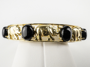 lot 113 image: Technibond Black Onyx Cabochon & Elephant Vermeil Hinged Bangle.