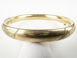 lot 118 image: Carl-Art  Etched Yellow Plated Base Metal Bangle.
