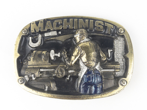 lot 35 image: The Great American Buckle Co. 1986 Machinist Base Metal Heavy Belt Buckle .