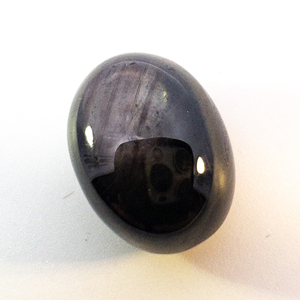 lot 87 image: NATURAL BLACK STAR SAPPHIRE - 16.58ct. Oval cabochon cut