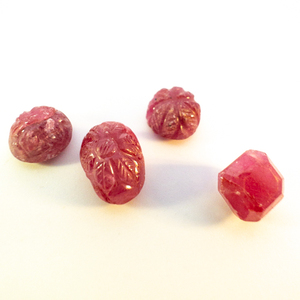 lot 323 image: Group of 4 NATURAL RUBY  - 11.24ct. (x3) Carved Flower Cabochons and one step cut