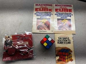 lot 89 image: Rubiks Cube with Solution Books and Harry Potter Glasses