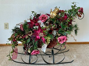 lot 269 image: Extra Large Holiday Sleigh with Faux Florals and Gold Cherub