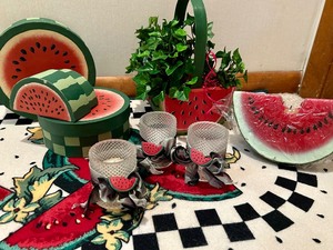 lot 147 image: Large Lot of Plastic Watermelon Serving Pieces, Rug, Candles, Wind Chime and More