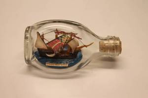 lot 218 image: Lot with Globe Clock, Aircraft Clock, and Ship in a Bottle Model