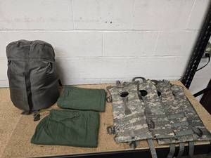 lot 3 image: Intermediate Sleeping bag - light green - with stuff sack (no holes), 2 OD green cotton dirty bags, and 4 ACU pattern hydration packs (bladders not included)