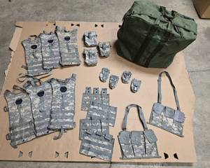 lot 15 image: OD Military bag, 2 MOLLE II 6 Magazine Bandoleer Ammunition Pouches, (adjustable shoulder strap), 4 MOLLE II Flashbang Pouches,  4 MOLLE II Triple Magazine Pouches, 3 individual First Aid Kit Pouches, 6 Hydration Packs