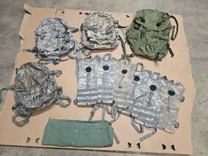 lot 17 image: 3 3-day assault packs, 1 Green large military backpack, 1 OD dirty bag and 6 hydration packs