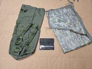 lot 31 image: OD Green Seabag Top Load (patched but otherwise in excellent condition), Wet Weather Poncho Linerblanket - WOOBIE - ACU (excellent condition), and 1 dial caliper