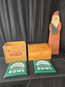 lot 11 image: Vintage Wooden Crates, Hollywood Bowl Seat Cushions, and Wooden Santa Decor