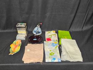 lot 51 image: Assorted Lot with Kitchen Towels, Decorative Plates, and Cassette Tapes
