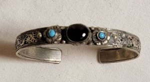 lot 74 image: Coiled Silver Cuff Bracelet with Onyx Center Stone and Turquoise Points