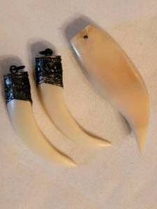 lot 152 image: Silver Capped Tooth Pendants