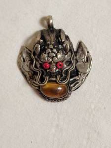 lot 76 image: Silver Dragon Head Pendant with Tiger Eye