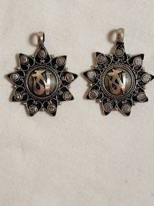 lot 137 image: Silver Pendant OM and Rays, pair