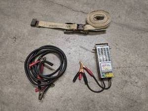 lot 8 image: Jumper cables, battery tester and heavy duty rachet strap
