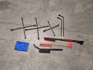 lot 5 image: 3 4-way lug wrenches (2 - 20 and 1 - 14 wrench), 2 lug nut wrenches (1 - 18 and 1 - 21) and 4 ice scrapers  snow brushes