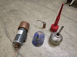 lot 16 image: Vintage pump oil can, 3 oil funnels and a drive motor