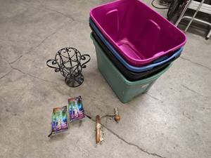 lot 30 image: 4 Rubbermaid style totes (no lids), decorative wrought iron plant stand 13 tall, wall light fixture and 2 Luma Flex lights