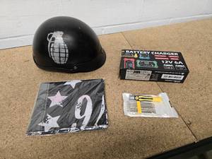 lot 47 image: Skull helmet, 1776 flag, 12V Battery Charger and mini tool kit
