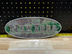 lot 84 image: New Idea Farm Implement Tractor Aluminum Emblem
