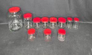 lot 165 image: Set of 11 Glass Storage Jars with Red Lids