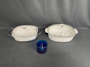 lot 202 image: Set of 2 White Stoneware Baking Dishes with Glass Lids and 1 Blue Glass Cup