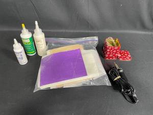 lot 207 image: Assorted Craft Supplies Including Adhesives, Tin Container, and Tools