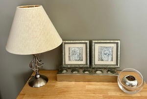 lot 72 image: Elegant Home Decor in Hues of Silver, Including a Lamp, Candles and Petite Pictures