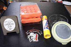 lot 386 image: Mixed Household Lot with Coffee Bar Sign, Baking Sheet, Glass Container, and More
