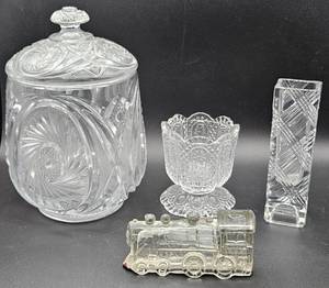 lot 65 image: Vintage EAPG McKee Aztec Biscuit Cracker Jar, Avon 1980 Fostoria Clear Cut Bud Vase, Glass Candy Container Train Single Window 888 and Avon Fostoria Candle Holder Goblet