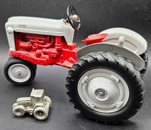 lot 52 image: Ertl Ford 990 Parts Mart 1990 Dealer Meeting Edition and 1993 Ford New Holland Genesis Miniature Pewter Tractor