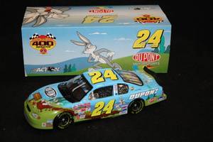 lot 1706 image: Action Collectibles #24 Jeff Gordon DuPont Loony Tunes Rematch 2002 Monte Carlo Diecast Metal Collectible 124 Scale (in original box)