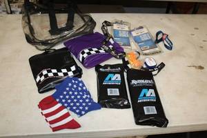 lot 1745 image: Lot of (10) Collectibles - (2) 2009 NASCAR Banking 500 Passes in Lanyards, (2) Inflatable Seats, (2) Rainmate Hooded Ponchos, (2) Pairs of Socks, Ear Plugs, Clear Carry Bag