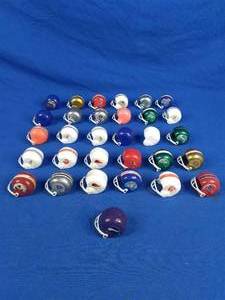 lot 269 image: Collection of 31 Mini NFL Football Helmets Vikings, Raiders, Redskins, Etc.