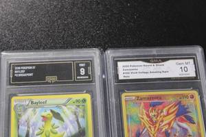 lot 69 image: 2016 Breakpoint Bayleef GMA 9 & 2020 Zamazenta Vivid Voltage Amazing Rare GMA 10