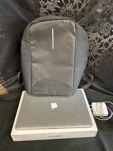 lot 68 image: Mac Book Pro (used) ( Powers on, No battery or OS)
